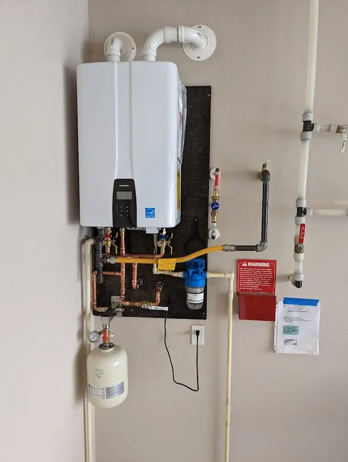 Professional plumber installing copper piping in a Haledon home